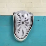 Dalí-inspired melting clock for surreal home decor. Battery-powered analog design, perfect for desks, shelves, or quirky conversation-starting displays.