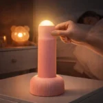 Pull switch LED night lamp on bedside table emitting soft warm light, playful rechargeable bedside lamp for bedroom and nursery use