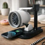 Mini jet engine desk fan with wireless charging and rotating turbofan blades on a modern office desk