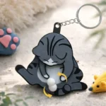Interactive cat paw keychain with spinning balls, funny fidget toy for cat lovers and novelty gift enthusiasts.