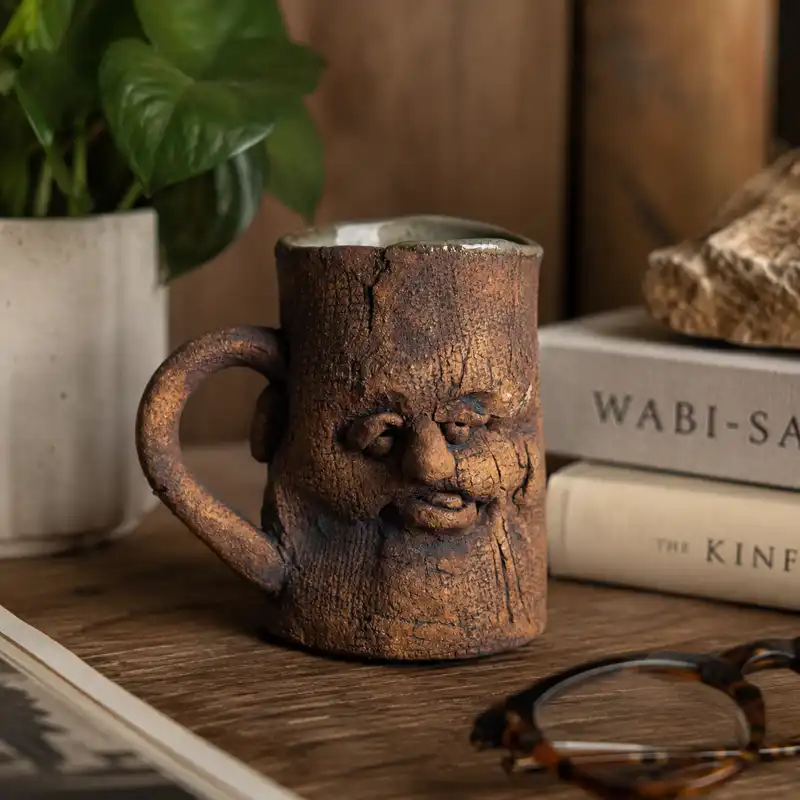 Handmade Face Mug with a sculpted human face, rustic ceramic texture, and 2 oz capacity displayed as an artistic pottery cup.