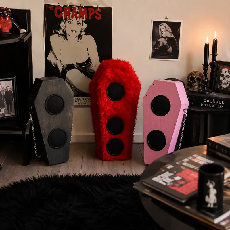 Handmade coffin bluetooth speaker with a gothic coffin-shaped design displayed as alternative home decor.