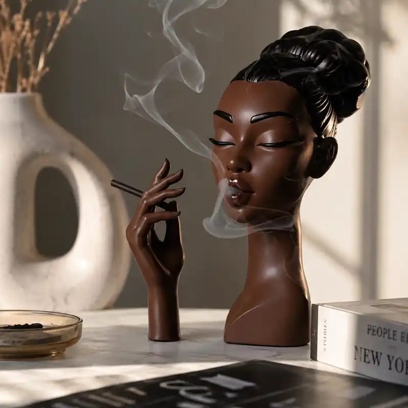 Black woman head incense burner shaped as a sculptural female bust with incense smoke